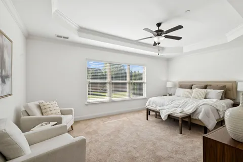 an empty room with a window and a ceiling fan
