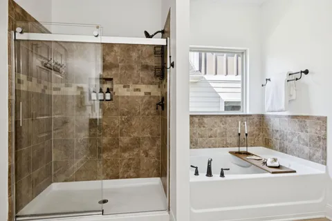 a view of a big house next to a yard with large trees