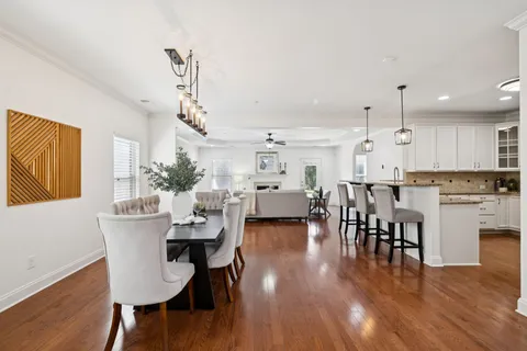 a view of a dining room with furniture and wooden floor