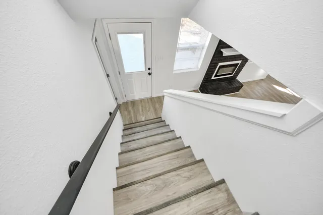 a view of entryway and hall with wooden floor