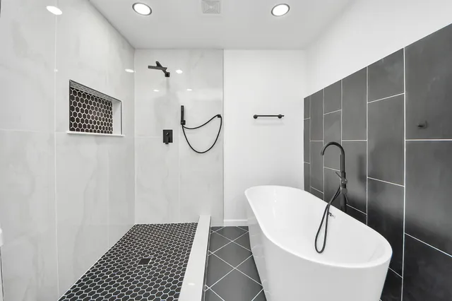 a bathroom with a bathtub and shower