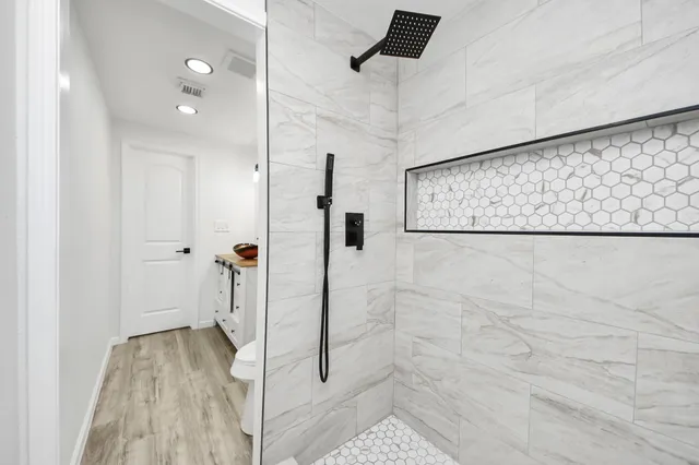a bathroom with a shower and a shower