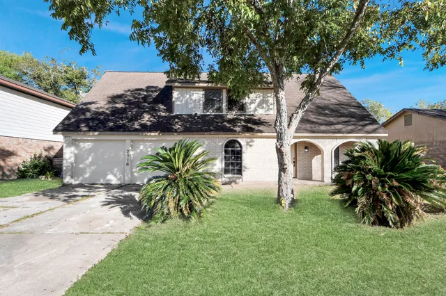 a house with palm tree in front of it