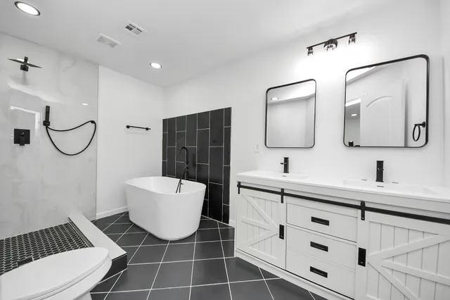 a bathroom with a toilet sink and mirror