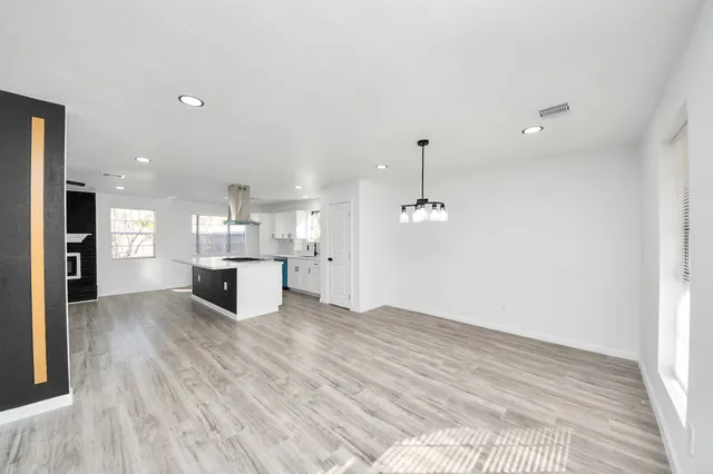 a view of kitchen and hall with wooden floor