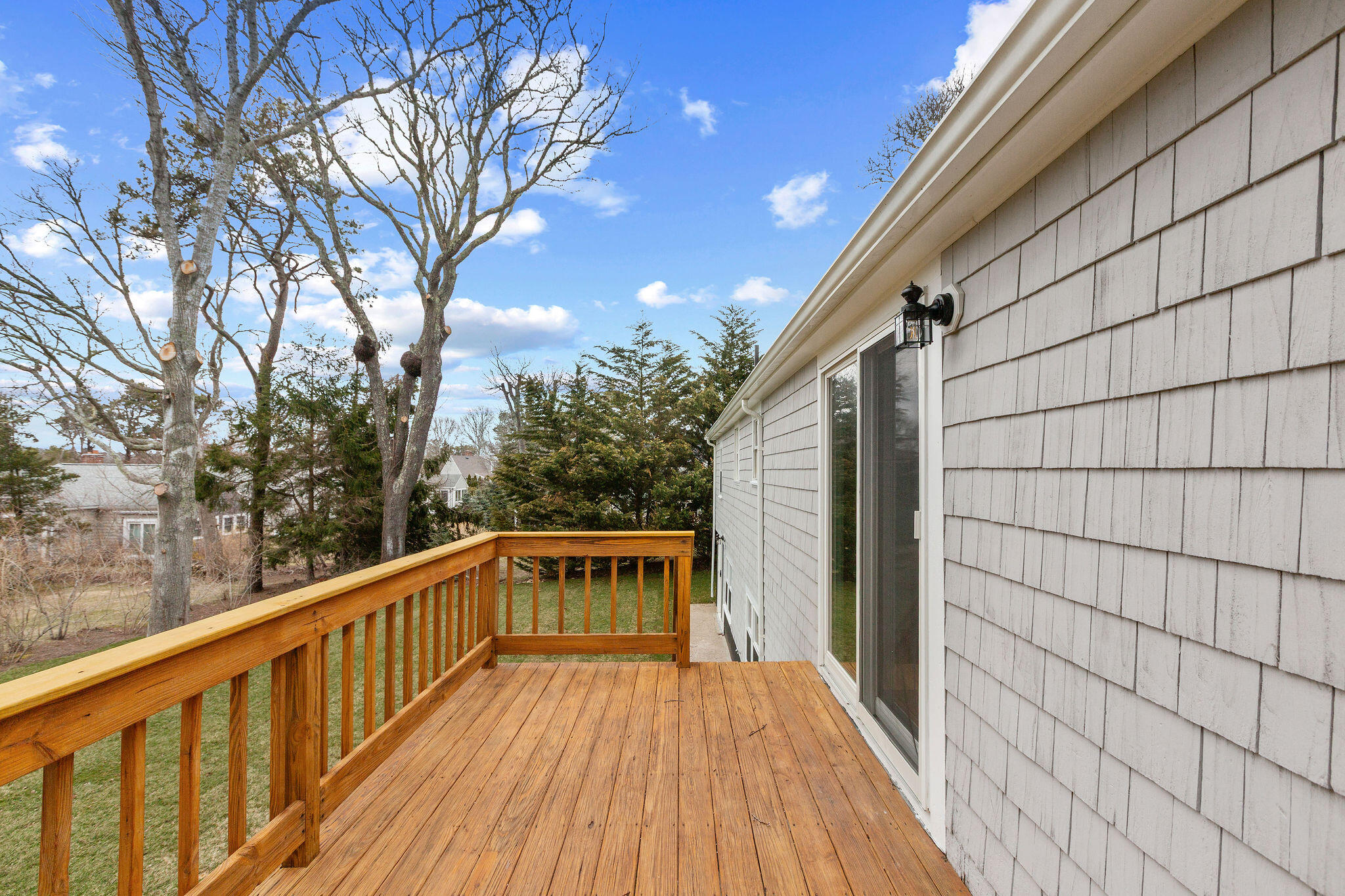 276 Scargo Hill Road South Dennis, MA 02660 - Photo 14 of 53 a balcony with wooden floor and trees