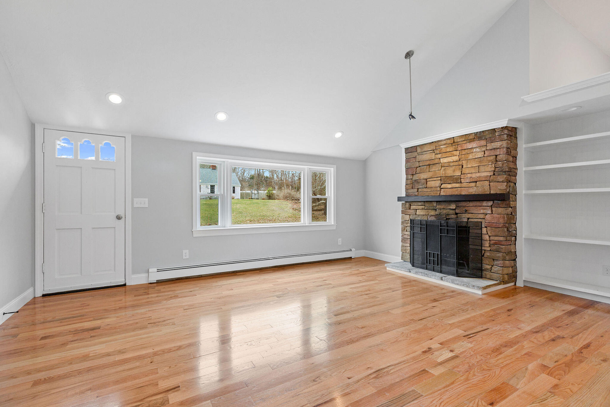 276 Scargo Hill Road South Dennis, MA 02660 - Photo 16 of 53 an empty room with wooden floor fireplace and windows