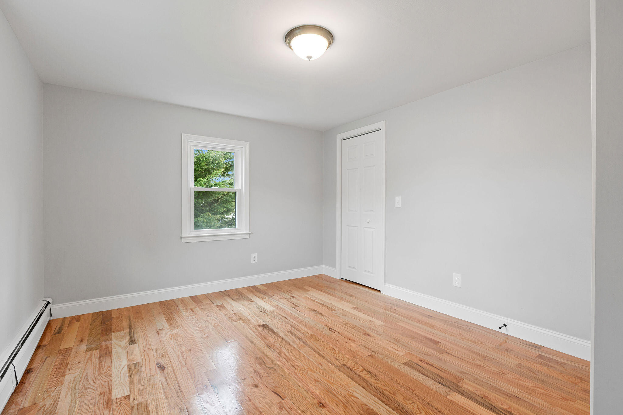276 Scargo Hill Road South Dennis, MA 02660 - Photo 40 of 53 an empty room with wooden floor and windows