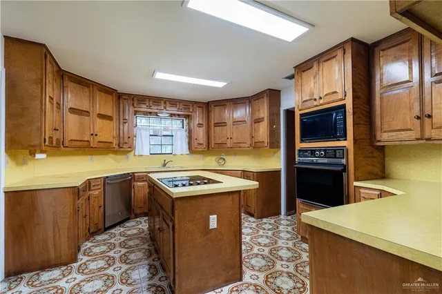 a kitchen with stainless steel appliances granite countertop a sink and cabinets