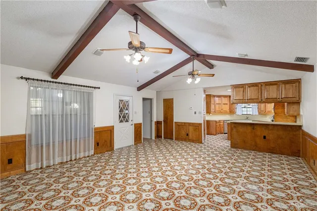a view of a chandelier in big room and a chandelier