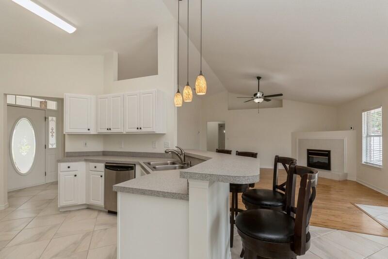 84 Inlet Drive Miramar Beach, FL 32550 - Photo 15 of 38 a kitchen with a stove a sink a dining table and chairs