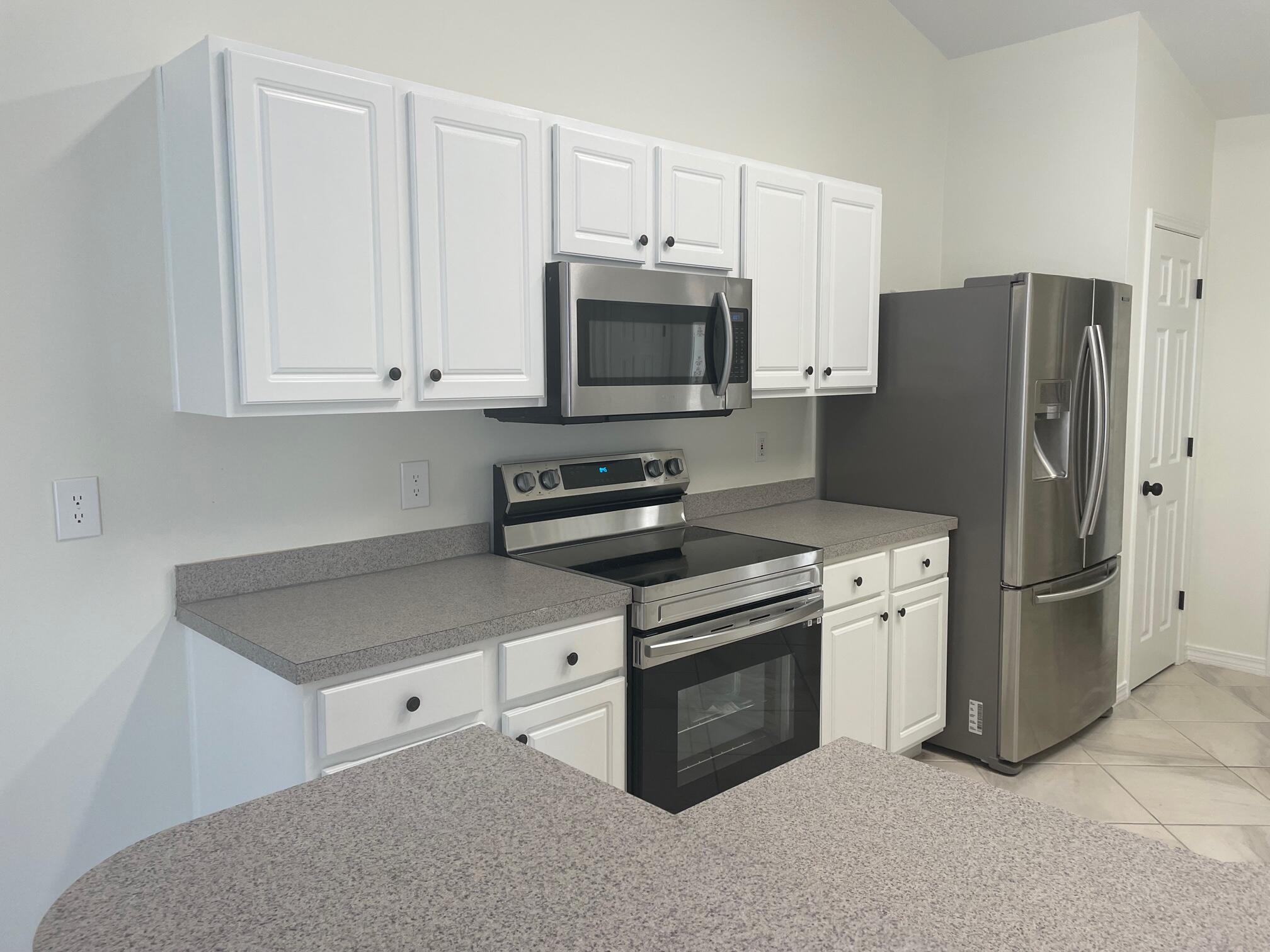 84 Inlet Drive Miramar Beach, FL 32550 - Photo 20 of 38 a kitchen with stainless steel appliances granite countertop a refrigerator stove and microwave