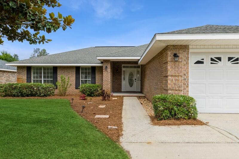84 Inlet Drive Miramar Beach, FL 32550 - Photo 3 of 38 a front view of a house with garden
