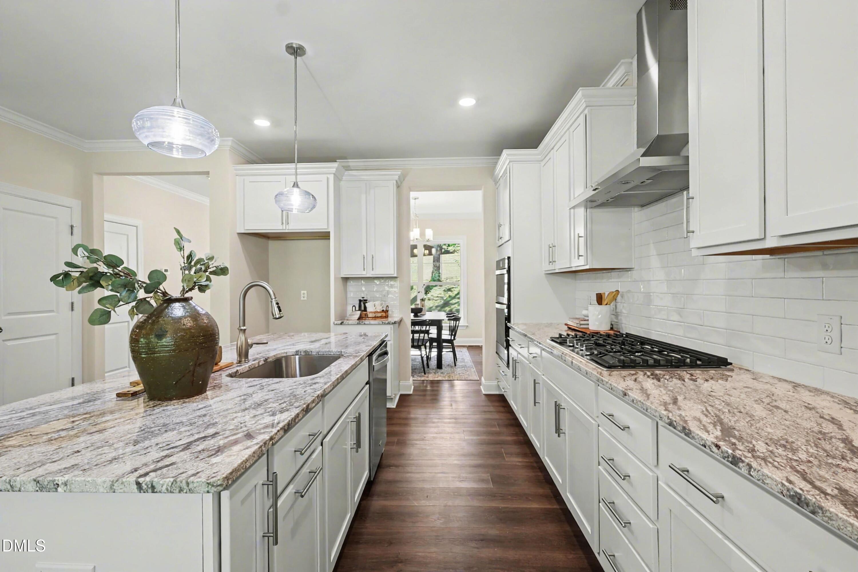 900 Southwest Maynard Road Cary, NC 27511 - Photo 4 of 51 a kitchen with counter top space cabinets and stainless steel appliances