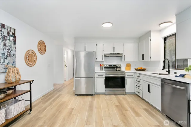 a kitchen with a refrigerator a stove top oven and a refrigerator
