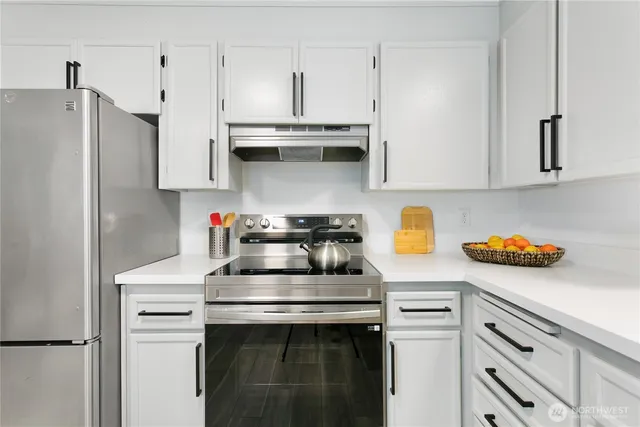 a kitchen with stainless steel appliances a sink stove and refrigerator