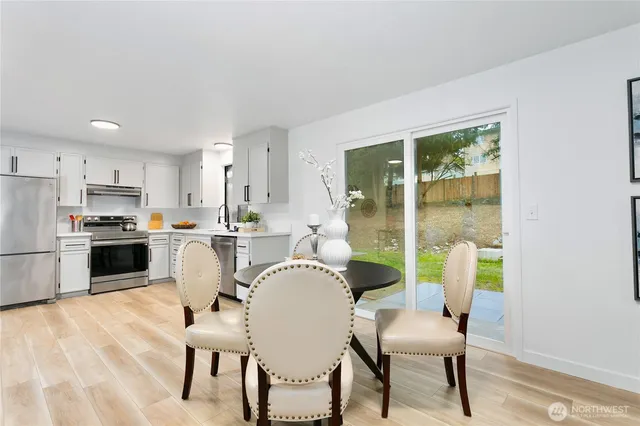 a dining room with furniture and a kitchen view