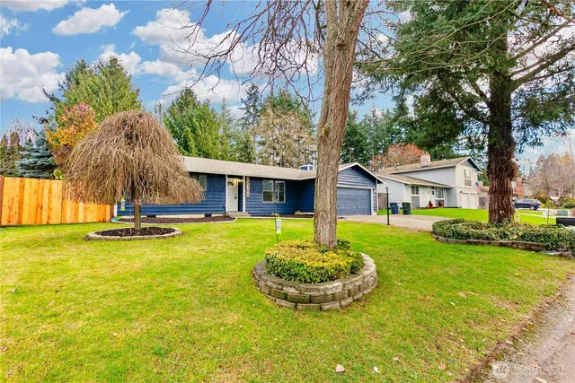 a view of a house with swimming pool and a garden