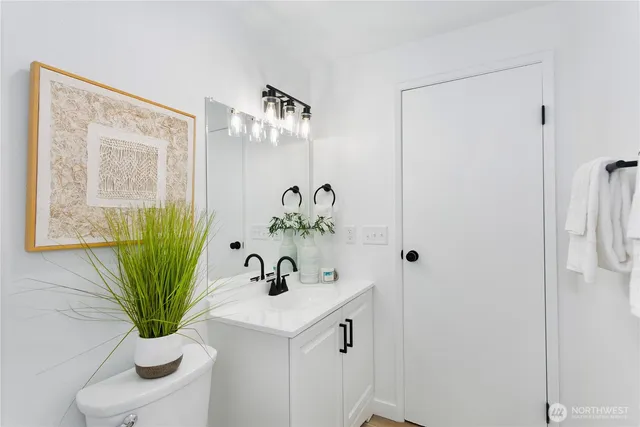 a bathroom with a sink a toilet and a mirror