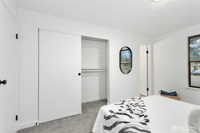 a bedroom with a bed and a window