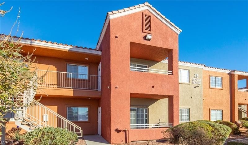 4730 East Craig Road, Unit 2142 Las Vegas, NV 89115 - Photo 2 of 8 This charming multi-story residence boasts vibrant stucco and classic tile roofing, creating an inviting exterior.