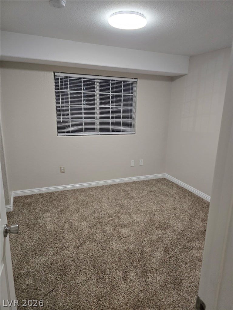 4730 East Craig Road, Unit 2142 Las Vegas, NV 89115 - Photo 6 of 8 This cozy room offers soft carpeting and a window, creating a comfortable and inviting atmosphere.