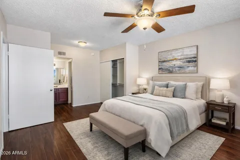 a spacious bedroom with a bed and a chandelier