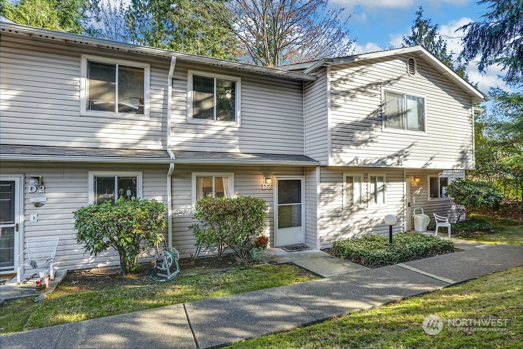 18910 Bothell Everett Highway, Unit D3 Bothell, WA 98012 - Photo 1 of 29 a front view of a house with garden