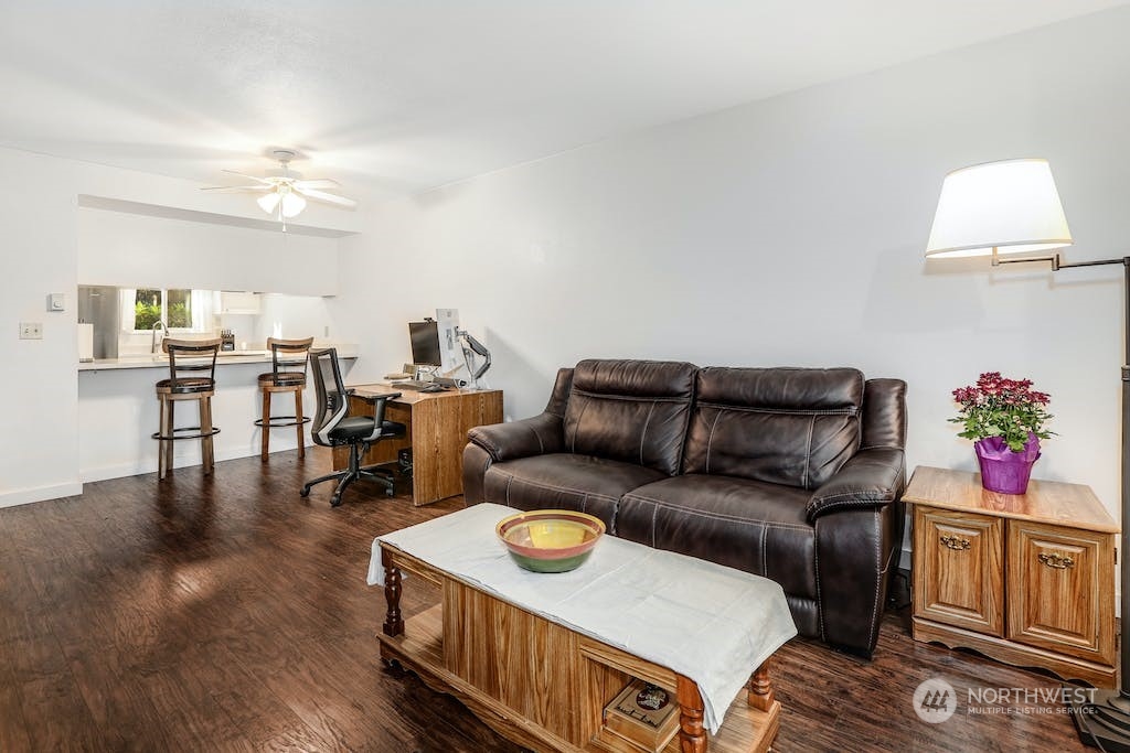 18910 Bothell Everett Highway, Unit D3 Bothell, WA 98012 - Photo 14 of 29 a living room with furniture and wooden floor