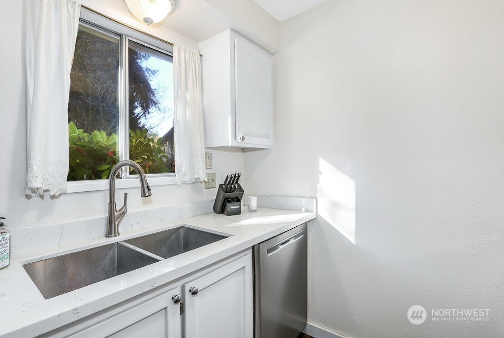 18910 Bothell Everett Highway, Unit D3 Bothell, WA 98012 - Photo 17 of 29 a kitchen with a sink and cabinets