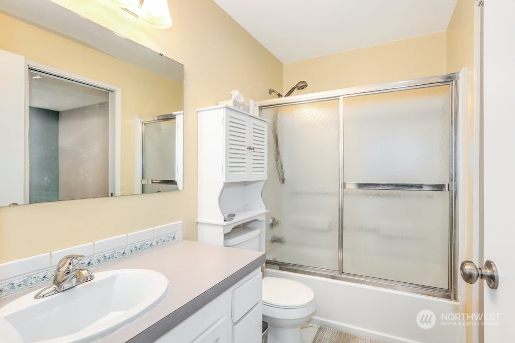 18910 Bothell Everett Highway, Unit D3 Bothell, WA 98012 - Photo 20 of 29 a bathroom with a sink toilet and shower