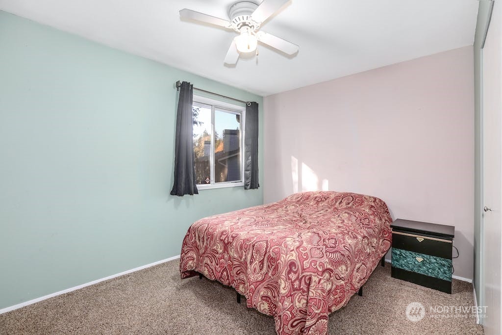 18910 Bothell Everett Highway, Unit D3 Bothell, WA 98012 - Photo 21 of 29 a bedroom with a bed and a window