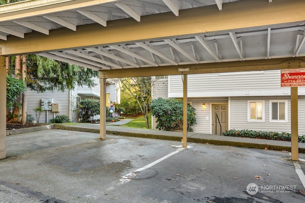 18910 Bothell Everett Highway, Unit D3 Bothell, WA 98012 - Photo 26 of 29 a view of a porch with a table and chairs under an umbrella
