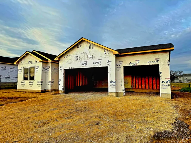 a view of a house with a yard and garage