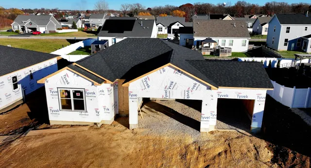a view of a house with backyard and sitting area
