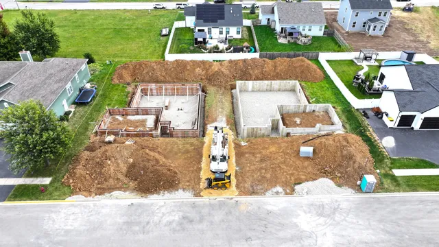 an aerial view of a house with a yard and lake view