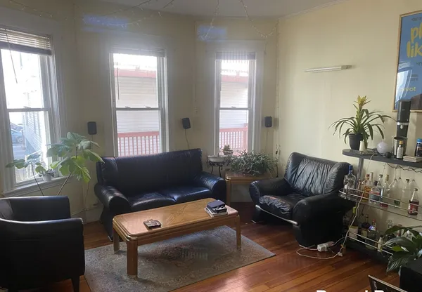 a living room with furniture rug and window