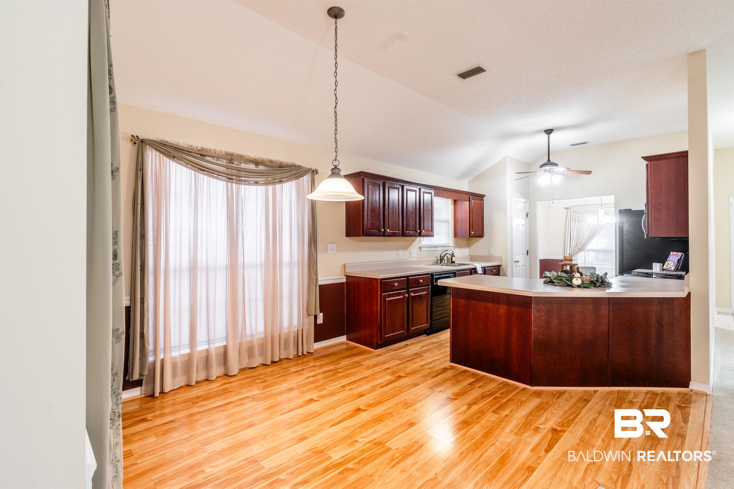 1784 Harrington Way Mobile, AL 36695 - Photo 6 of 18 Kitchen featuring ceiling fan, hanging light fixtures, refrigerator, light wood-type flooring, and vaulted ceiling