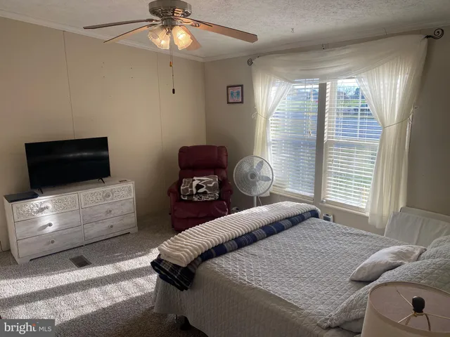 a bedroom with furniture and a flat screen tv