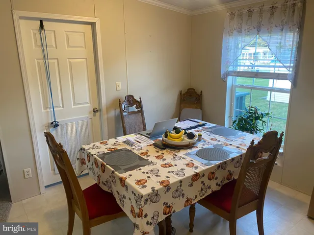 a view of a dining room with furniture a chandelier and wooden floor