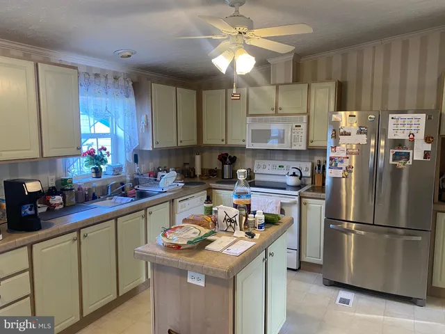 a kitchen with a refrigerator a sink and cabinets