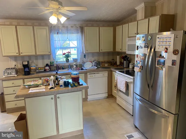 a kitchen with stainless steel appliances a refrigerator sink and cabinets