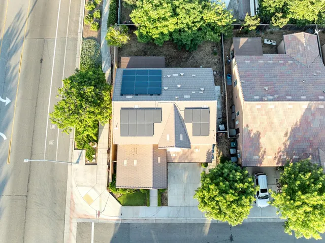 an aerial view of a house with a yard and potted plants