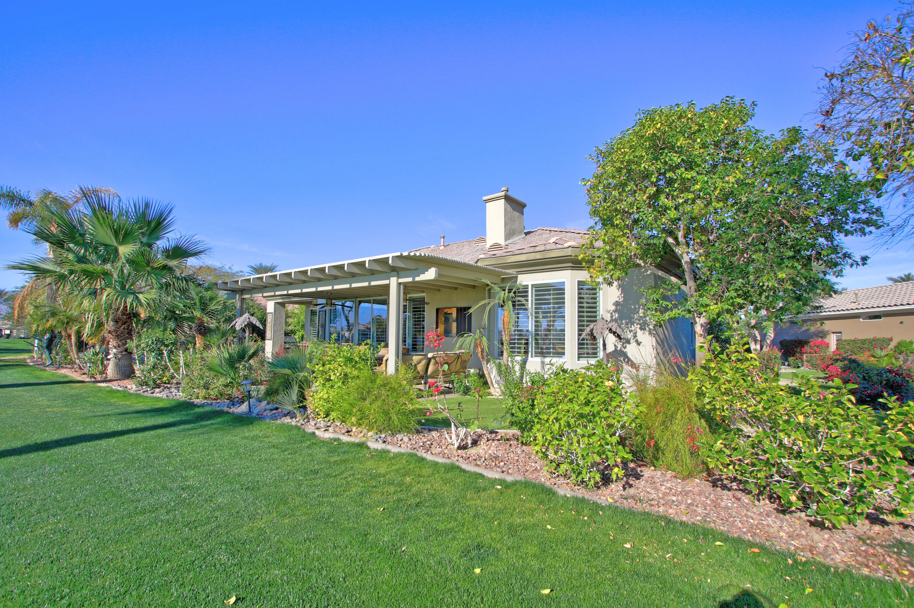 44530 Knightswood Road Indio, CA 92201 - Photo 2 of 38 a front view of a house with a garden