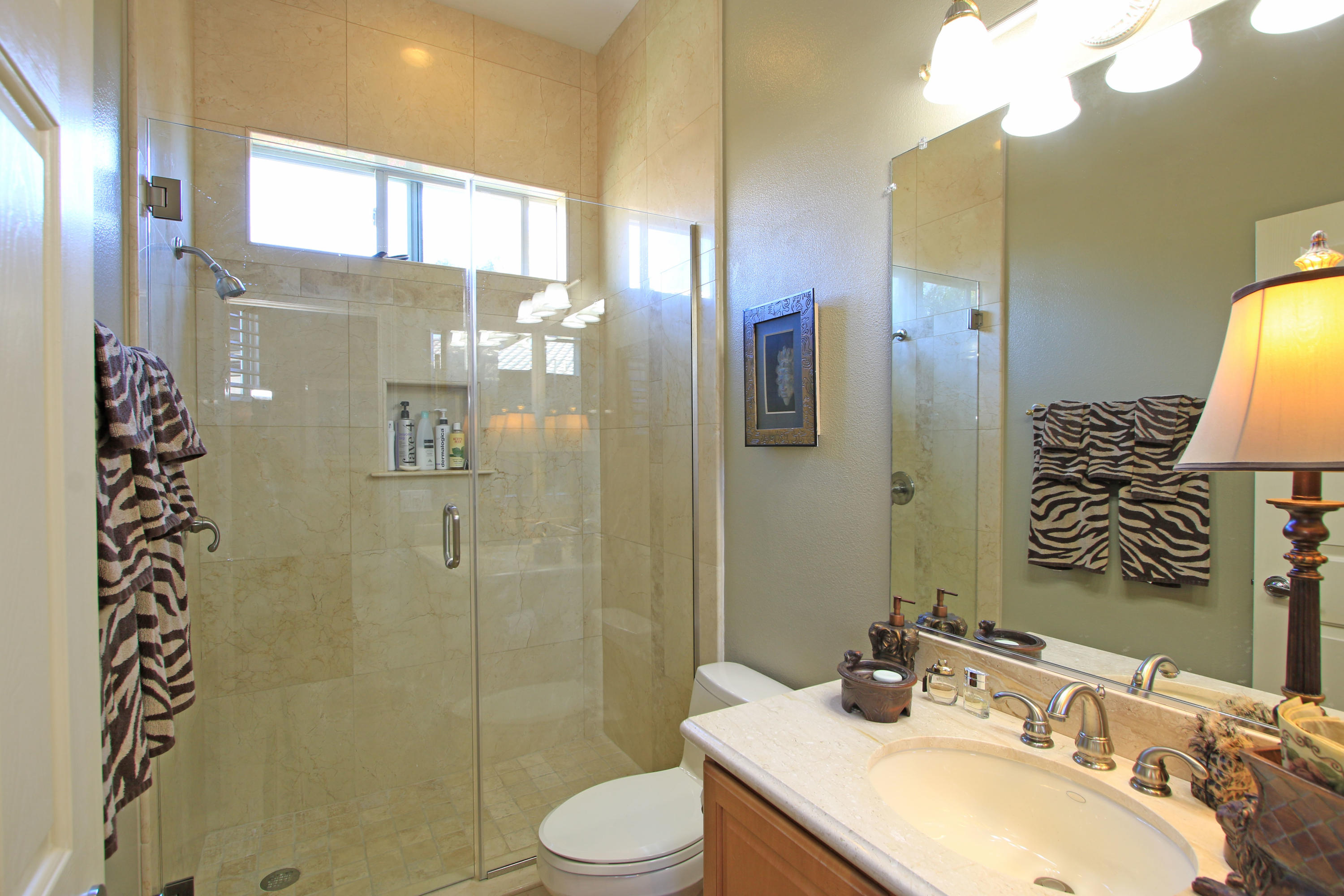44530 Knightswood Road Indio, CA 92201 - Photo 21 of 38 a bathroom with a granite countertop sink toilet and shower