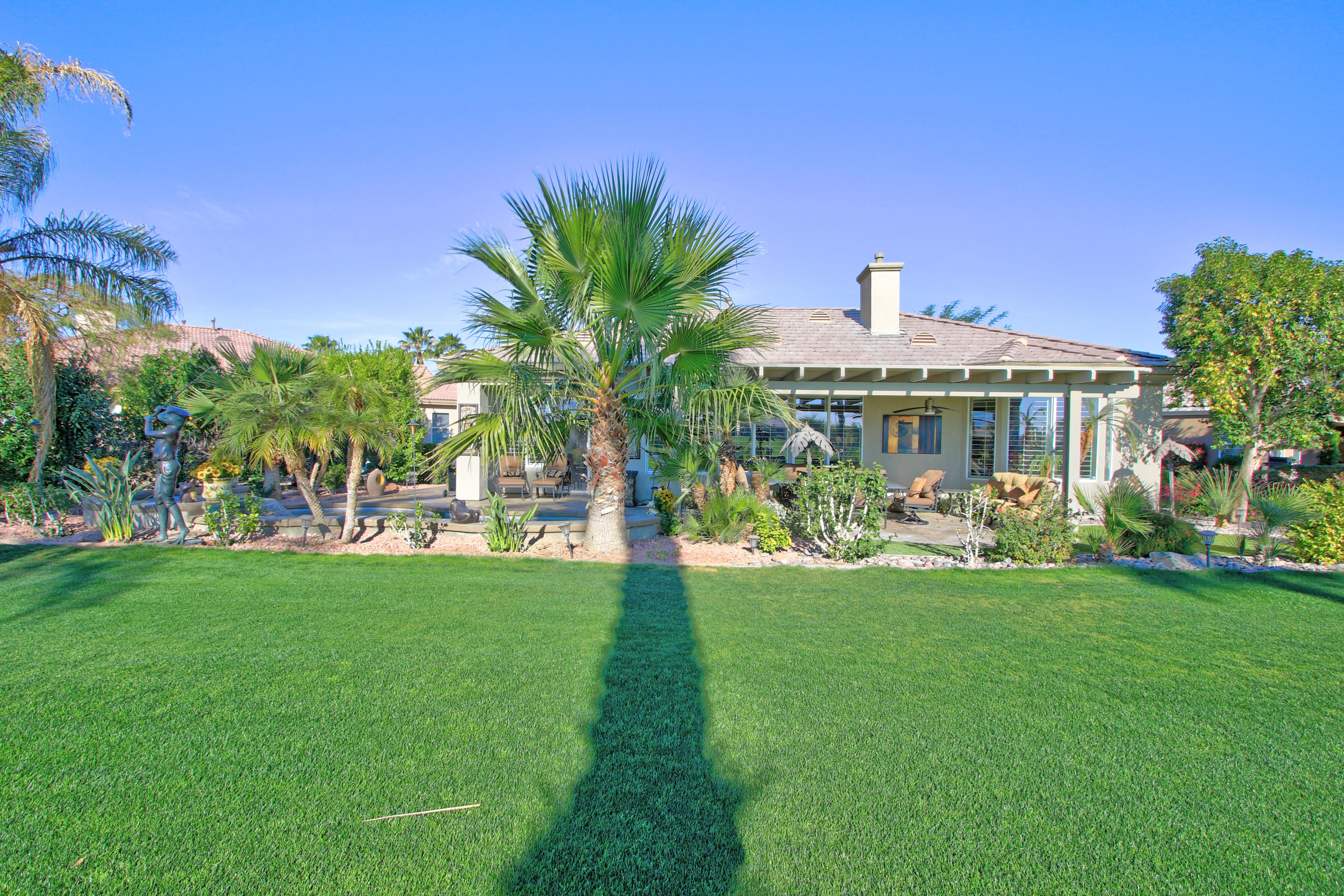 44530 Knightswood Road Indio, CA 92201 - Photo 25 of 38 a view of a house with a big yard and potted plants