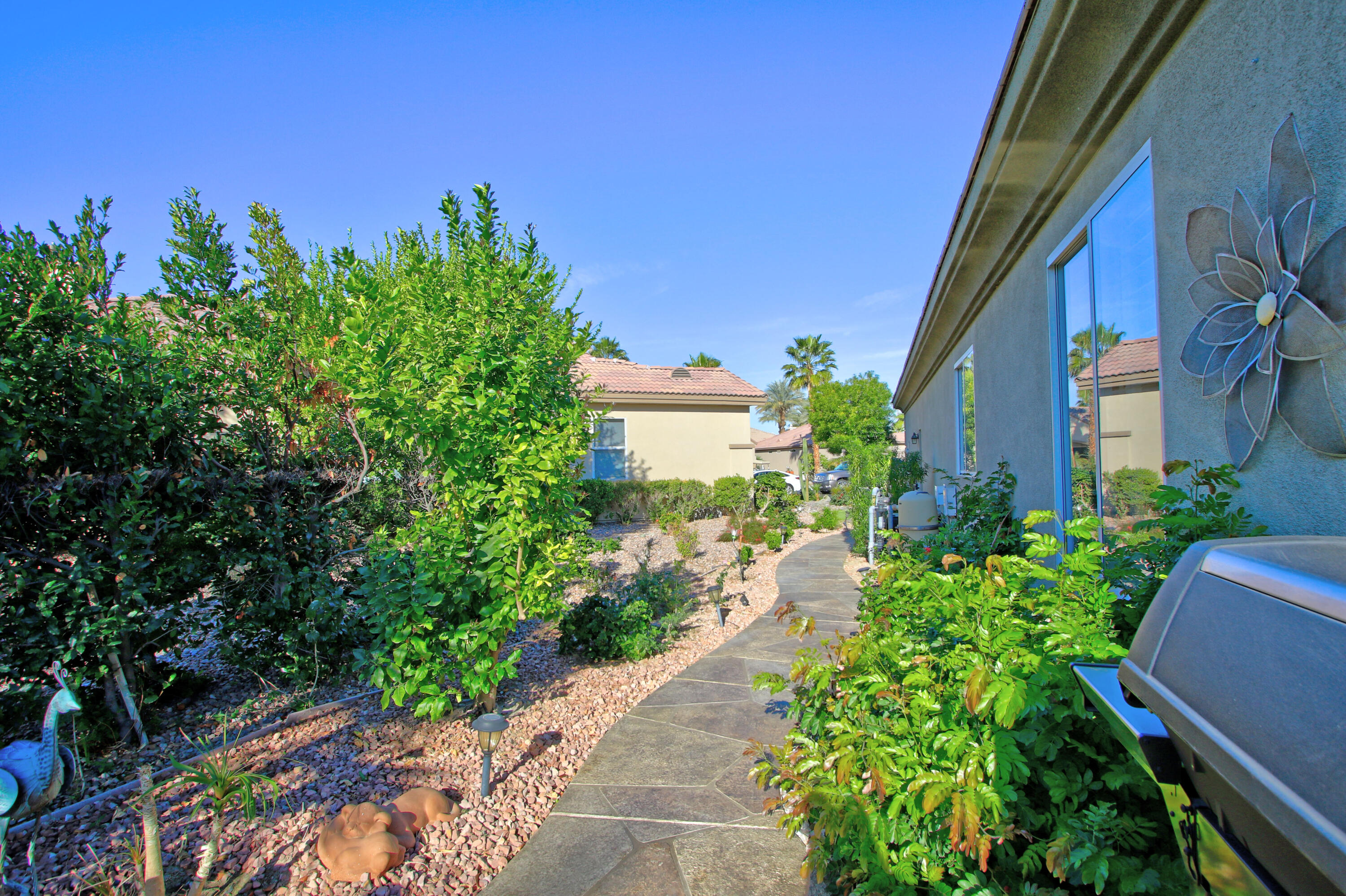 44530 Knightswood Road Indio, CA 92201 - Photo 34 of 38 a view of a garden with pathway