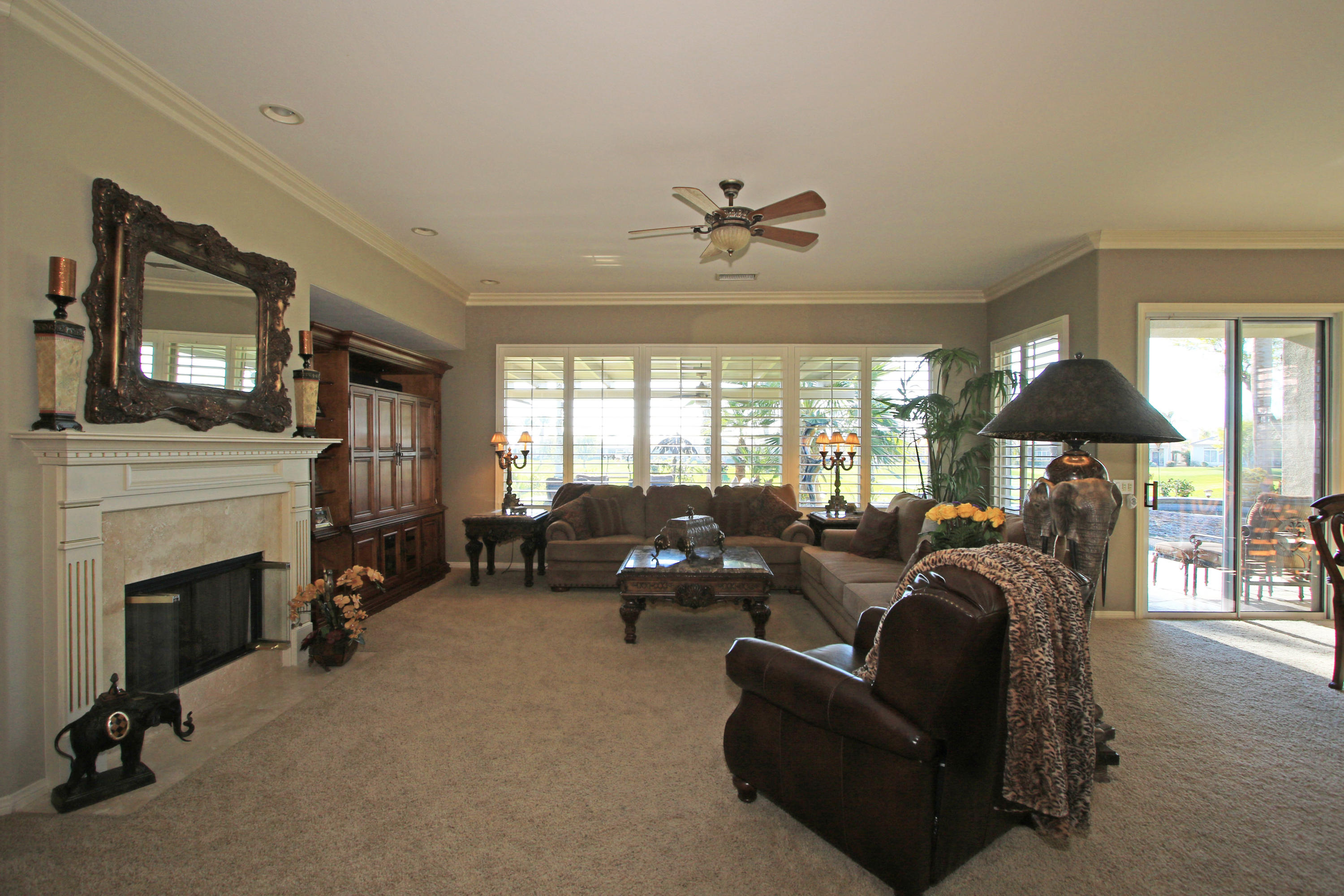44530 Knightswood Road Indio, CA 92201 - Photo 7 of 38 a living room with furniture a fireplace and a flat screen tv