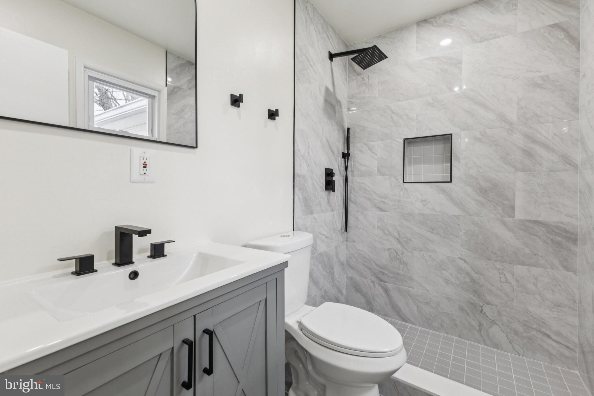 2202 Princess Anne Lane Woodbridge, VA 22191 - Photo 13 of 25 a bathroom with a sink a toilet and shower curtain