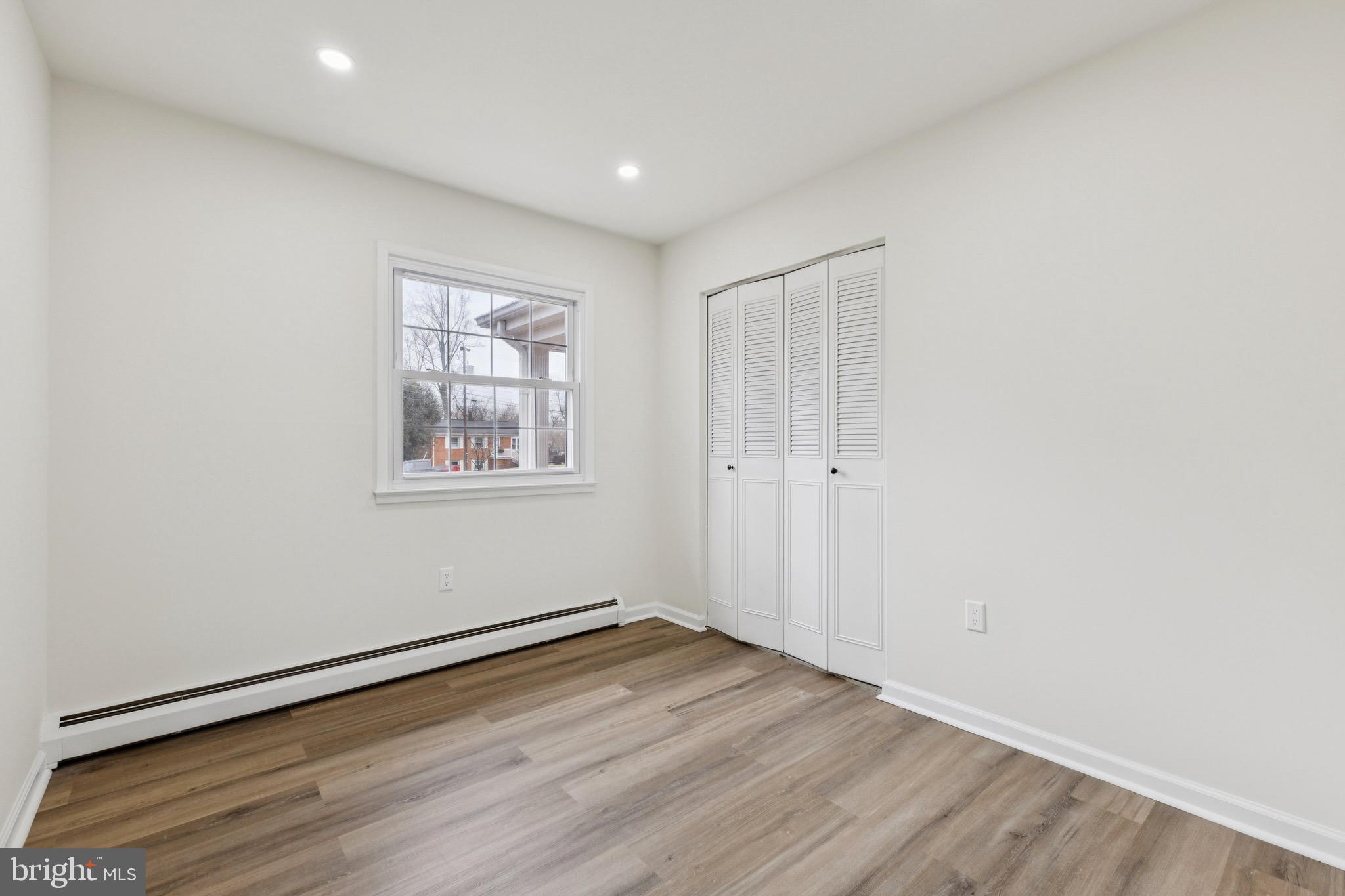 2202 Princess Anne Lane Woodbridge, VA 22191 - Photo 17 of 25 an empty room with wooden floor and windows